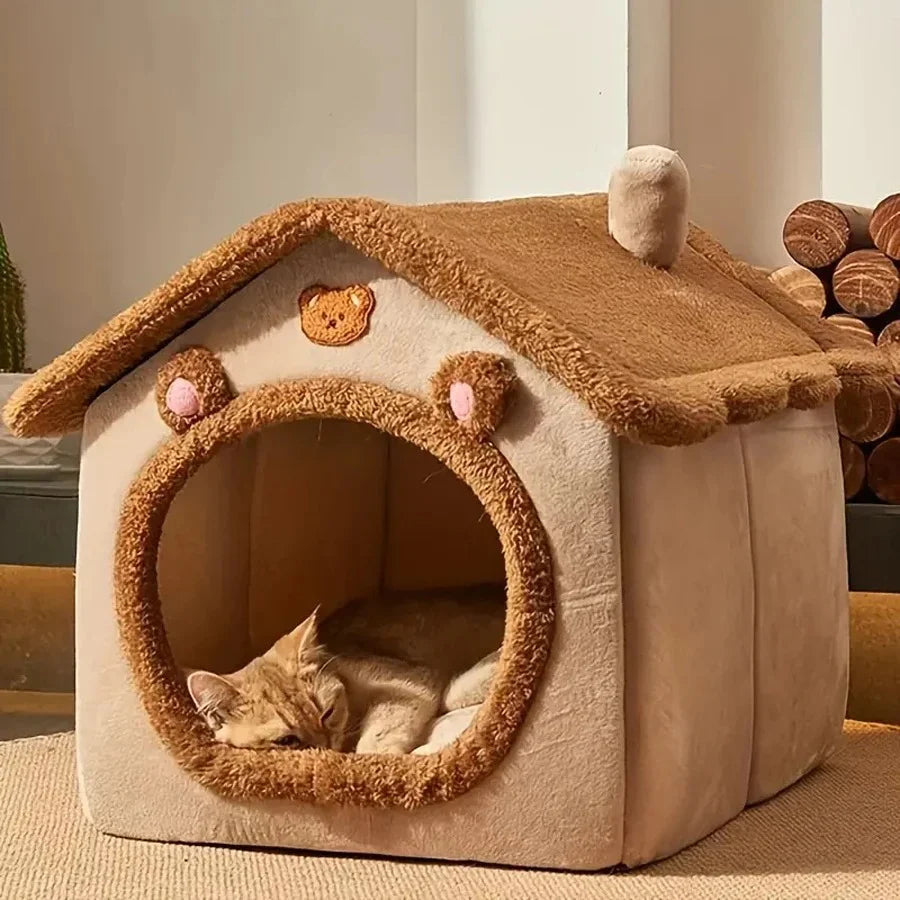 Cat house with a cat inside, resembling a bear's den, on a neutral background.