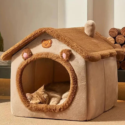 Cat house with a cat inside, resembling a bear's den, on a neutral background.